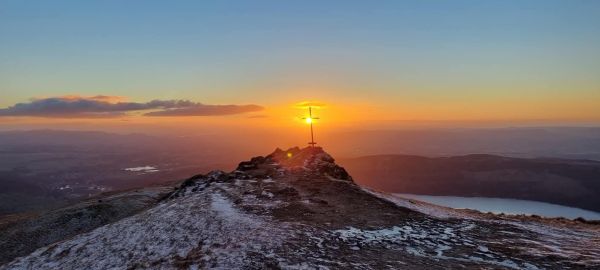 Sun rising behind Sgt Harry Lawrie memorial cross